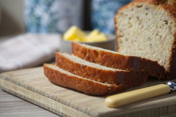 Close-up of freshly baked banana bread slices on a wooden board, Shallow depth of field with blurred background