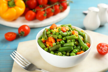 Mix of fresh vegetables served on light blue wooden table