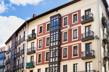 Fototapeta na wymiar Facade of old buildings in Bilbao old town street. Residential houses in the city. Real estate business, classic architecture style concepts