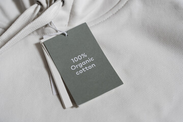 Paper label on a white 100% organic cotton hoodie