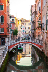 Fototapeta na wymiar A small arch bridge across canal of Venice, Italy.