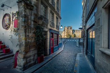 Fototapeta na wymiar Paris, France - April 3, 2021: Small cosy street with City Hall in background in Paris