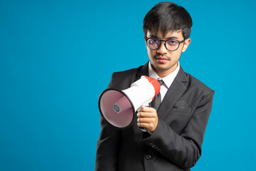 Businessman holding megaphone isolated on blue background