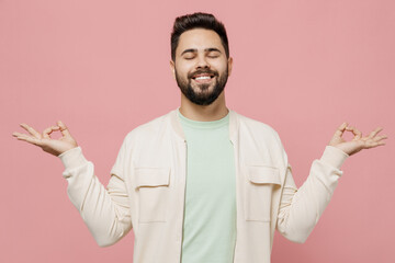 Young man in trendy jacket shirt hold spreading hands in yoga om aum gesture relax meditate try to...