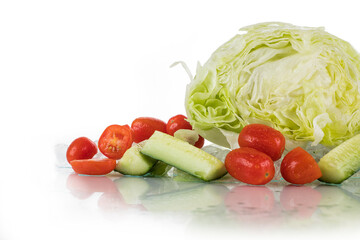 Vegetables on a white background with ice cubes and crushed ice