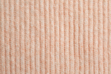 Beautiful pale pink knitted fabric as background, top view