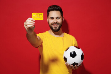 Satisfied blithesome young bearded man football fan in yellow t-shirt cheer up support favorite...