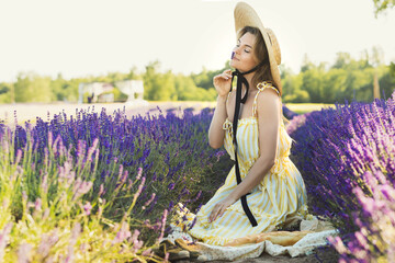 Beautiful young woman in a field full of lavender flowers
