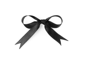 Elegant black ribbon tied in bow isolated on white, top view