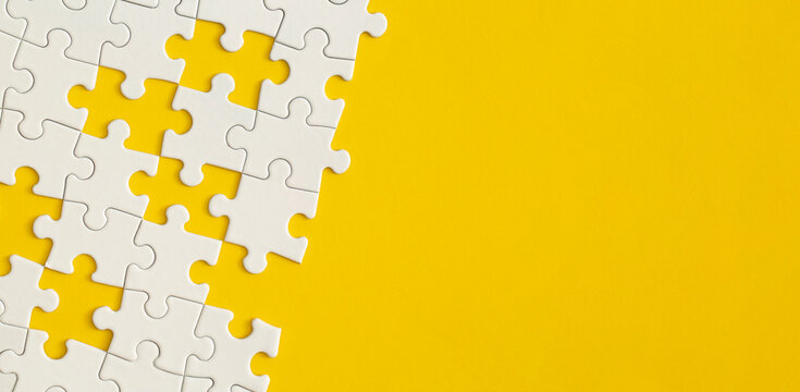 White details of puzzle on yellow background.