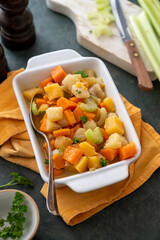 Root vegetable casserole with sweet potato, celery, parsnip, carrot. Comfort baked food.