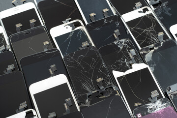 A Heap with the Various broken screens lying one on top of another. Devices are prepared for utilization.
