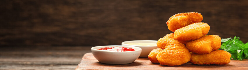 Homemade chicken nuggets and sauces with copy space banner