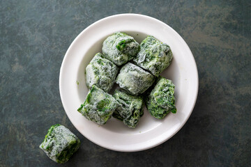 Frozen spinach cubes close up. Healthy eating ingredient.