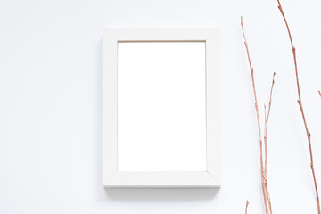 empty white photo frame and dry branches