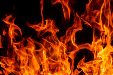 Abstract flame, fire flame texture, background. Blurred moving tongues of fire on a dark background.