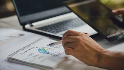 Businessman analyzing company annual financial report balance sheet statement working with...
