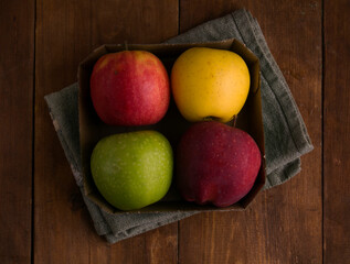 set of apples in a box on a wooden background