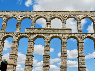 Fototapeta na wymiar Front view of roman aqueduct in Segovia, Spain. Stone columns of medieval water transporting construction