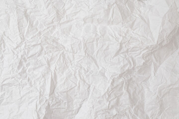 Crumpled white paper background.