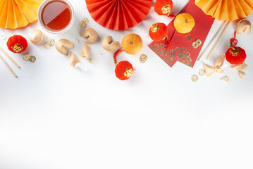 Chinese new year background. Red and golden yellow flatlay with traditional Chinese new year decor,...