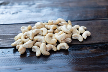 Raw cashew nuts on a wooden table close-up