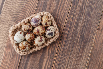 Obraz na płótnie Canvas Group of quail eggs are put on clear tray on wooden table.