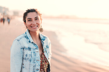 latin young woman happy smiling on the beach, looking at camera, portrait in La Serena