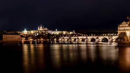 Prague Charles bridge and castle at night, panorama, Czech Republic.
