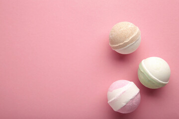 Bath bombs on pink concrete background. Bathroom composition