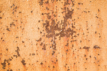 Weathered rough yellow  painted surface with patterns of cracks and peeling. Grunge texture for background . Copy space