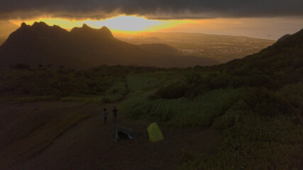 Aerial view of Port Louis City and mountains from 'Le Pouce' Mountain during a cloudy and rainy sunset