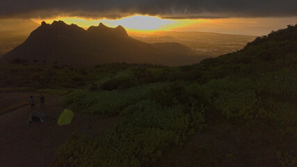 Aerial view of Port Louis City and mountains from 'Le Pouce' Mountain during a cloudy and rainy sunset
