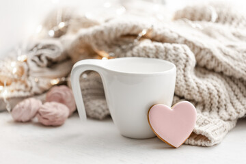 Composition for Valentine's Day with a cup and a heart-shaped gingerbread.