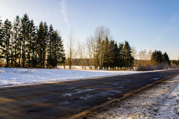 Beautiful landscape of a snowy winter road during the day