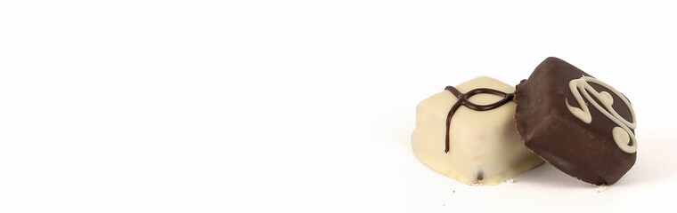 Chocolate black and white candies on a white background.