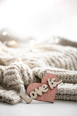 Fototapeta na wymiar A decorative heart among cozy knitted items. Valentine's Day holiday concept.