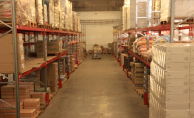 Obraz premium Warehouse with lots of products, blurred view. Wholesale business