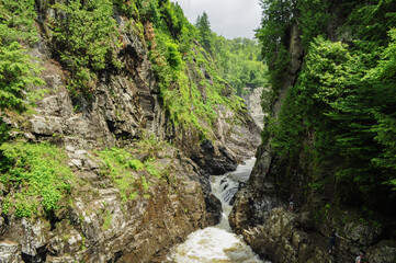Waterfall in the forest crashing down between the rocks people rock climbing