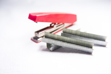red stapler and staples, foreground selective focus on staples