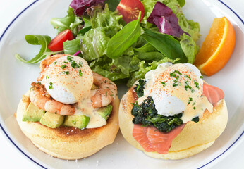 Kiseki Pancake Eggs Benedict with herbs and vegetable in white plate closeup