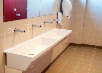 New sinks, faucets, taps, hand dryers and shower stalls in a locker room