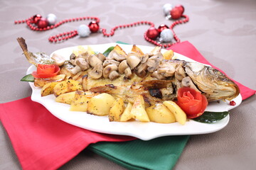 Roasted Carp fish with potatoes and mushrooms