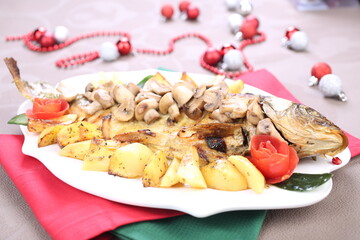Roasted Carp fish with potatoes and mushrooms
