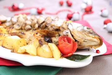 Roasted Carp fish with potatoes and mushrooms