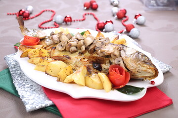 Roasted Carp fish with potatoes and mushrooms