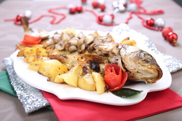 Roasted Carp fish with potatoes and mushrooms