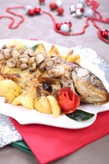 Roasted Carp fish with potatoes and mushrooms
