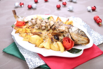 Roasted Carp fish with potatoes and mushrooms