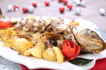Roasted Carp fish with potatoes and mushrooms
